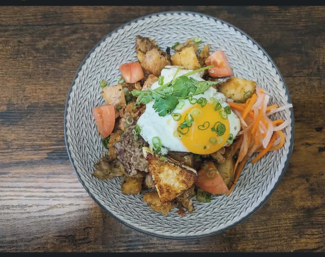 “Bánh Mì” hash bowl — crispy potato hash, fried egg, pickled carrot and daikon, cilantro.