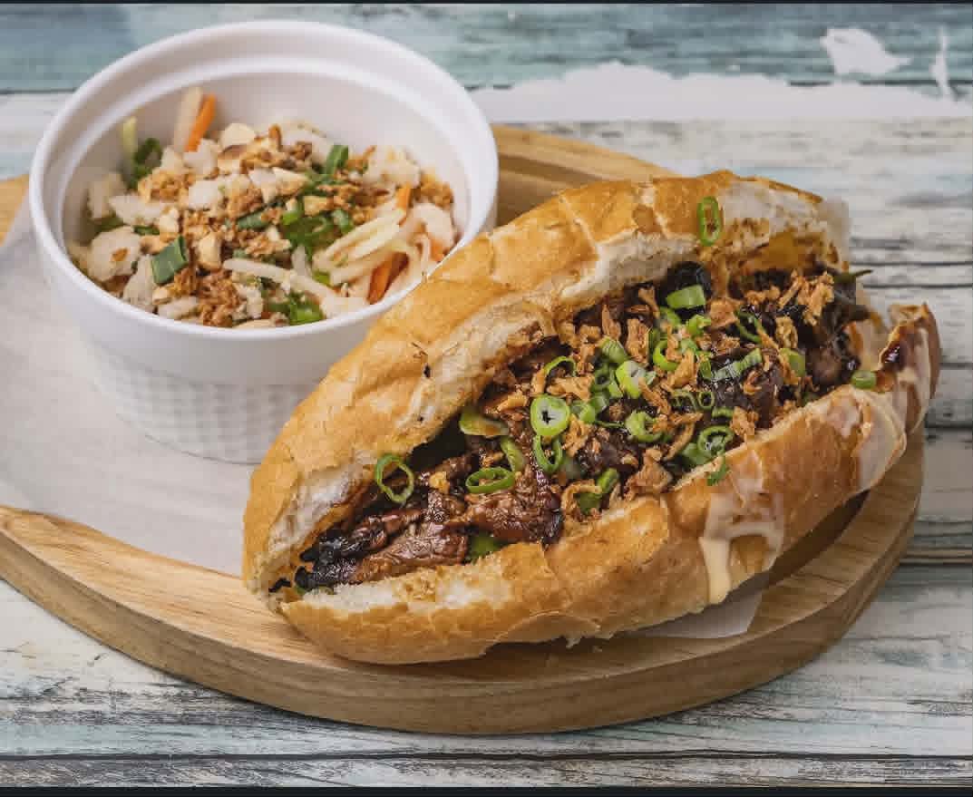 Bánh mì bò sa tế — lemongrass satay beef on a crusty baguette with scallion and crispy onion.