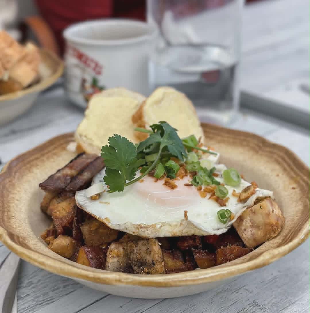 Vietnamese breakfast hash with crispy pork belly, sausage, a fried egg and warm baguette.